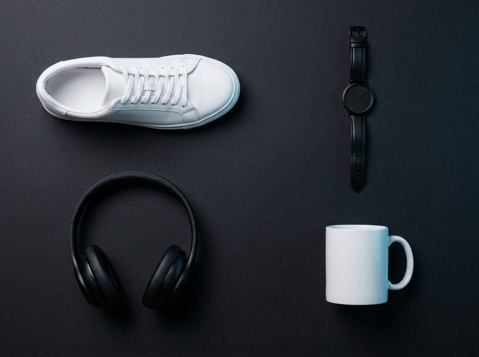 Product photo with a sneaker, a wristwatch, headphones and a mug